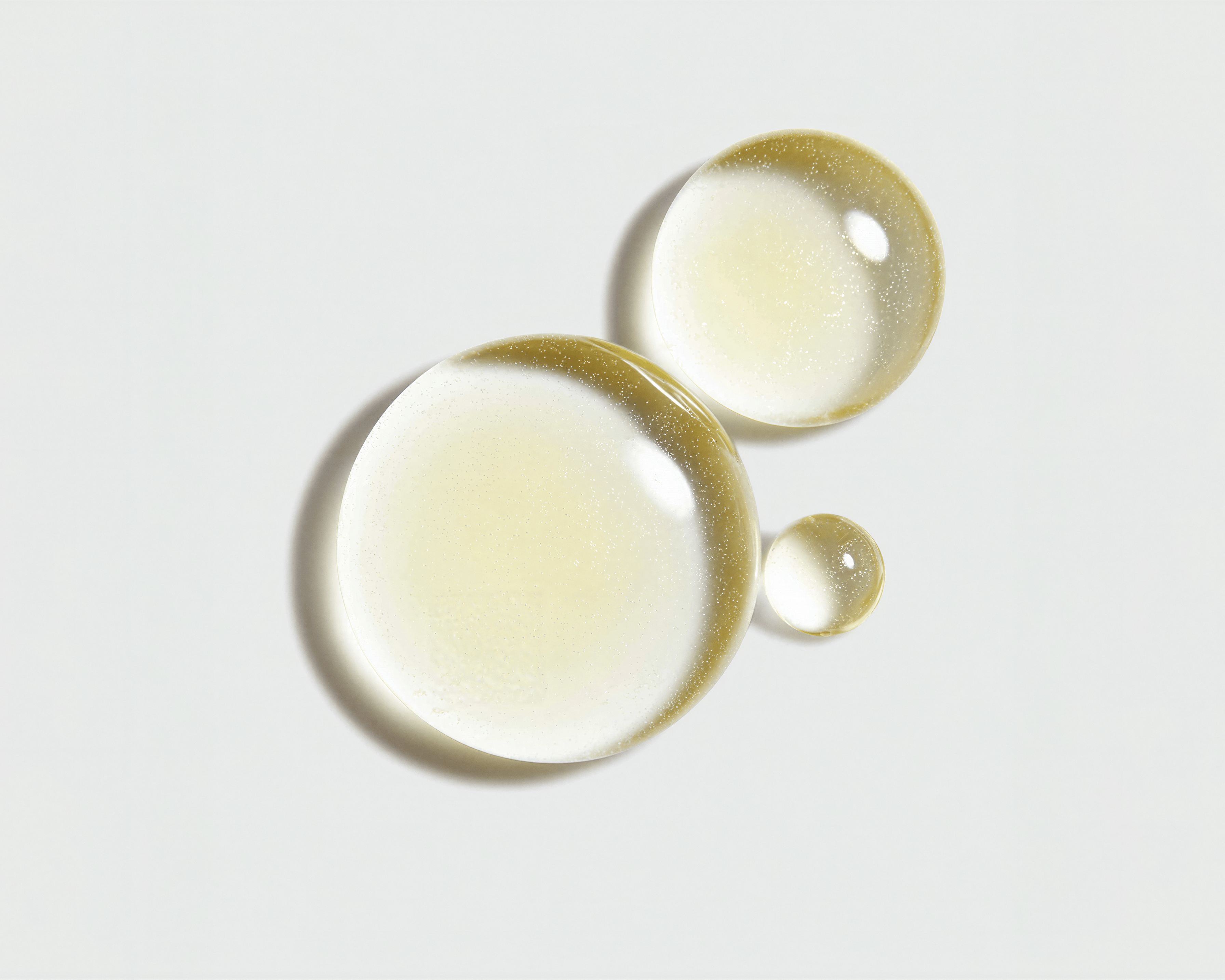 Golden Vitamin C and ferulic acid serum droplets illustrating antioxidant skincare science