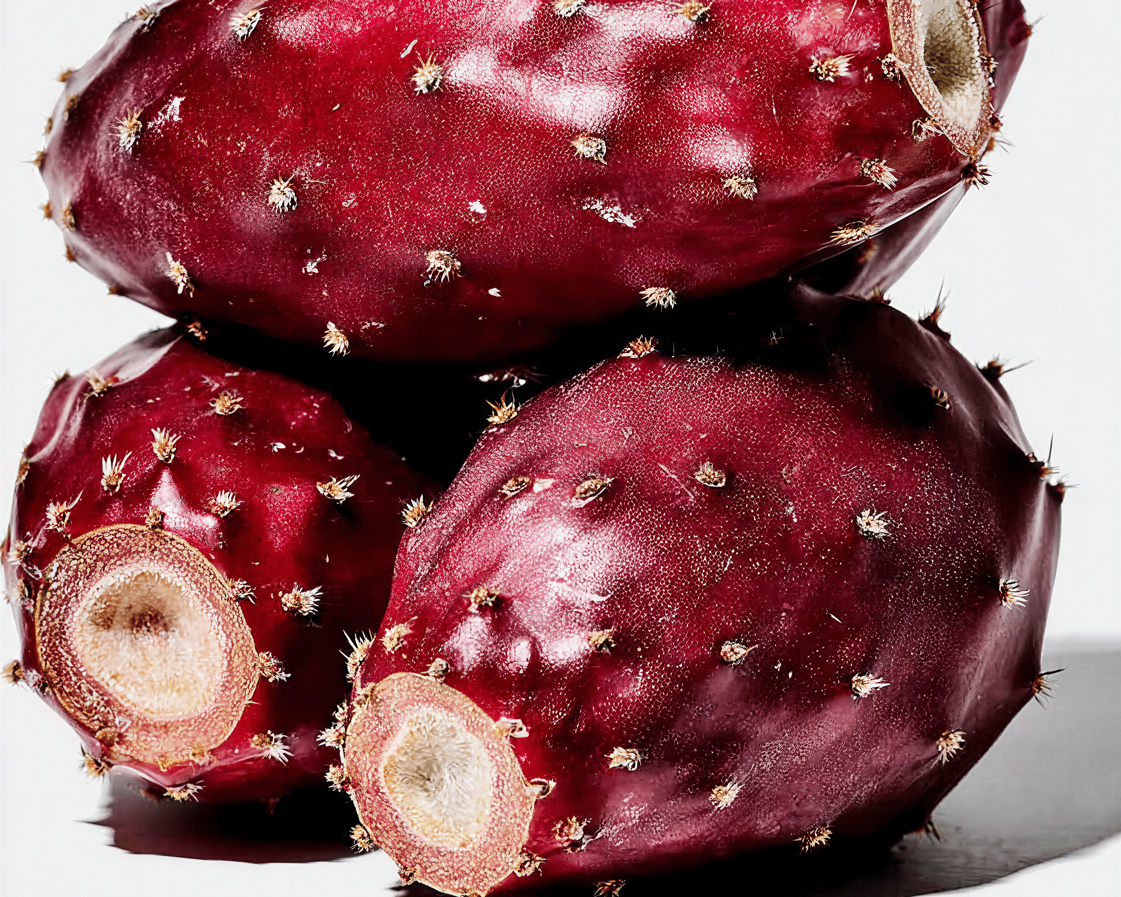 Fresh prickly pear cactus fruit cut open showing vibrant red flesh — key ingredient in Blanchard Skincare's Prickly Pear HA Daily Moisturizer