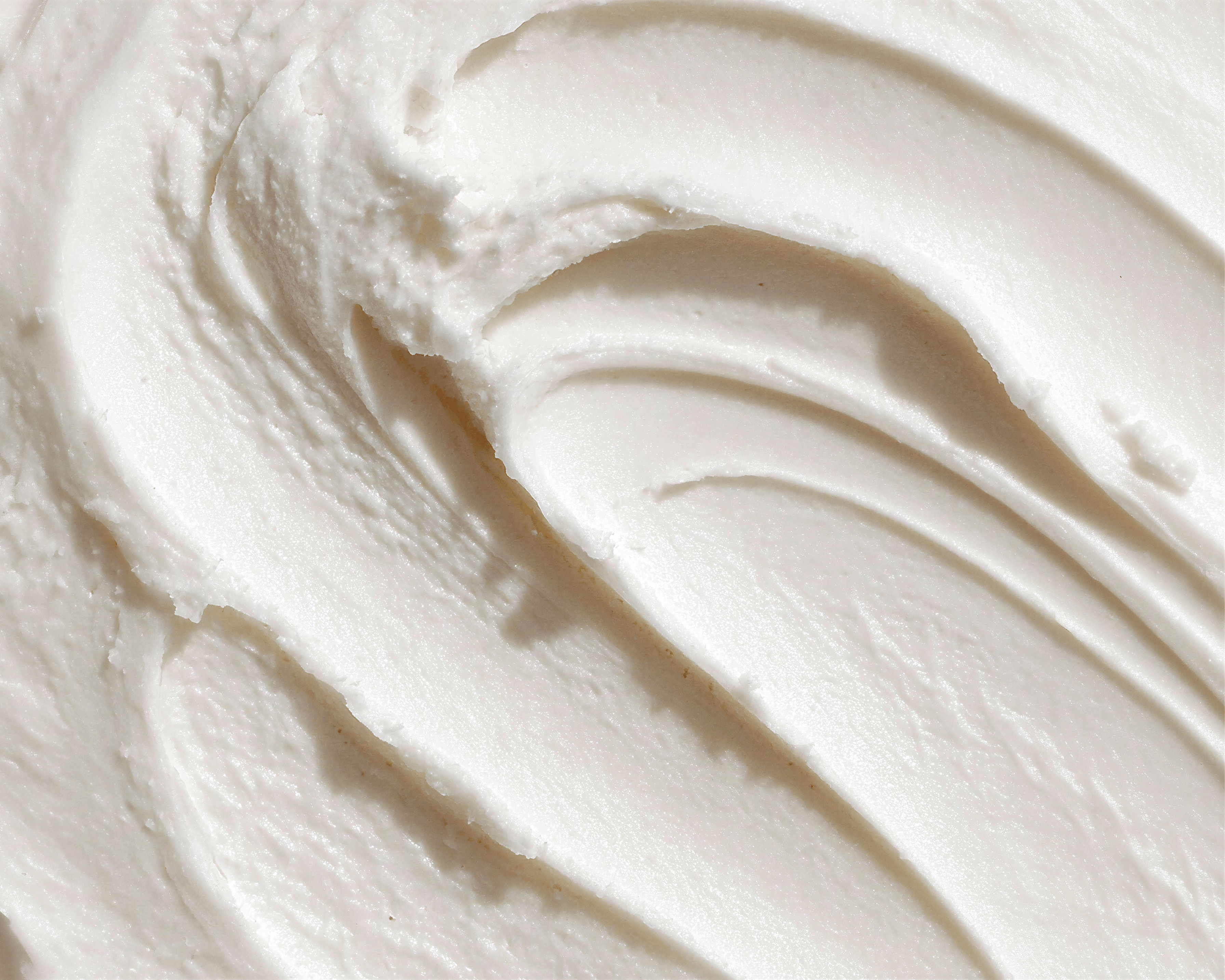 Close-up texture of yogurt cream representing skin microbiome benefits in Blanchard Skincare's Rosa Damascena Cleansing Gel