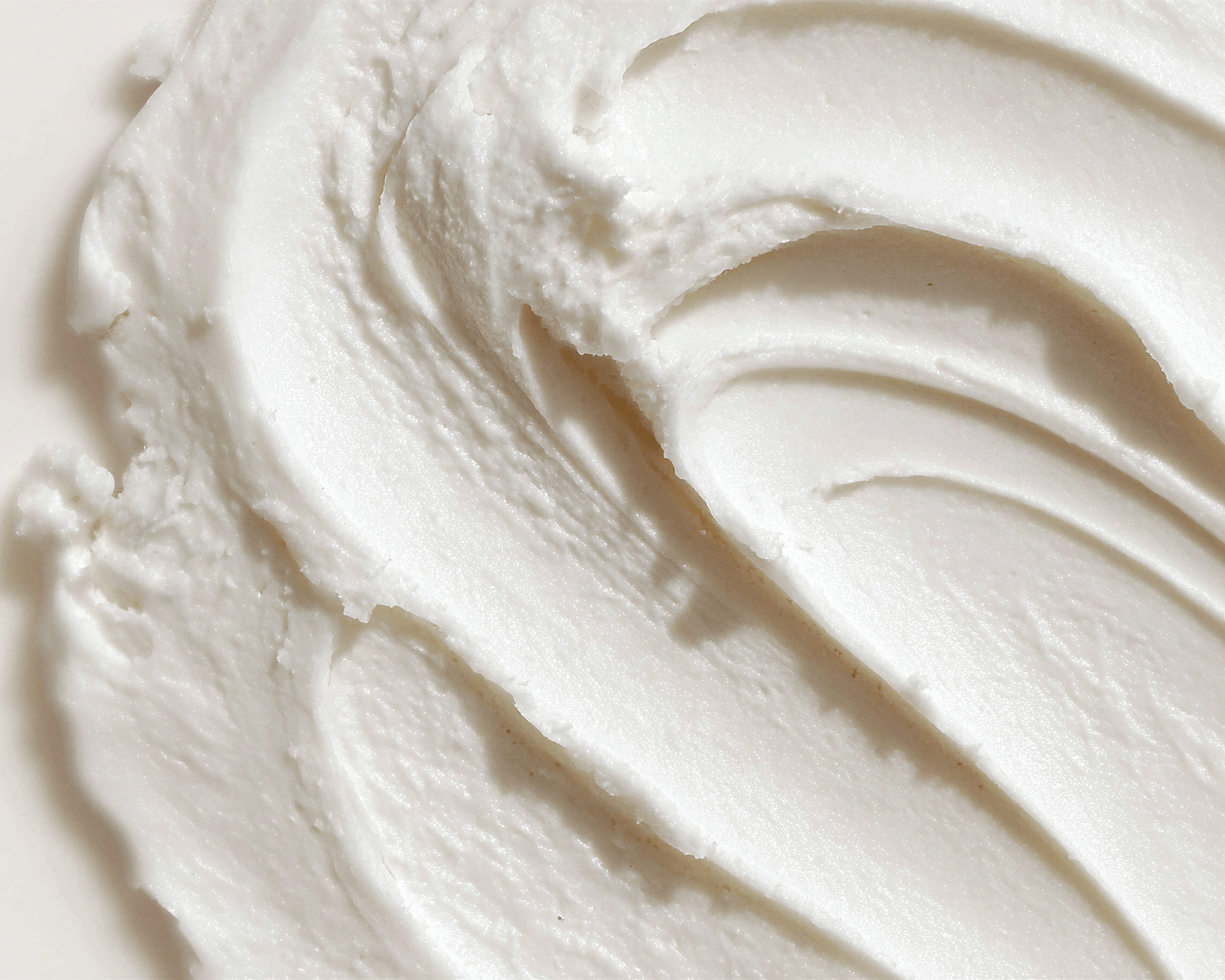 Close-up texture of yogurt powder extract — prebiotic ingredient in Blanchard Skincare's Rosa Damascena Daily Cleansing Gel
